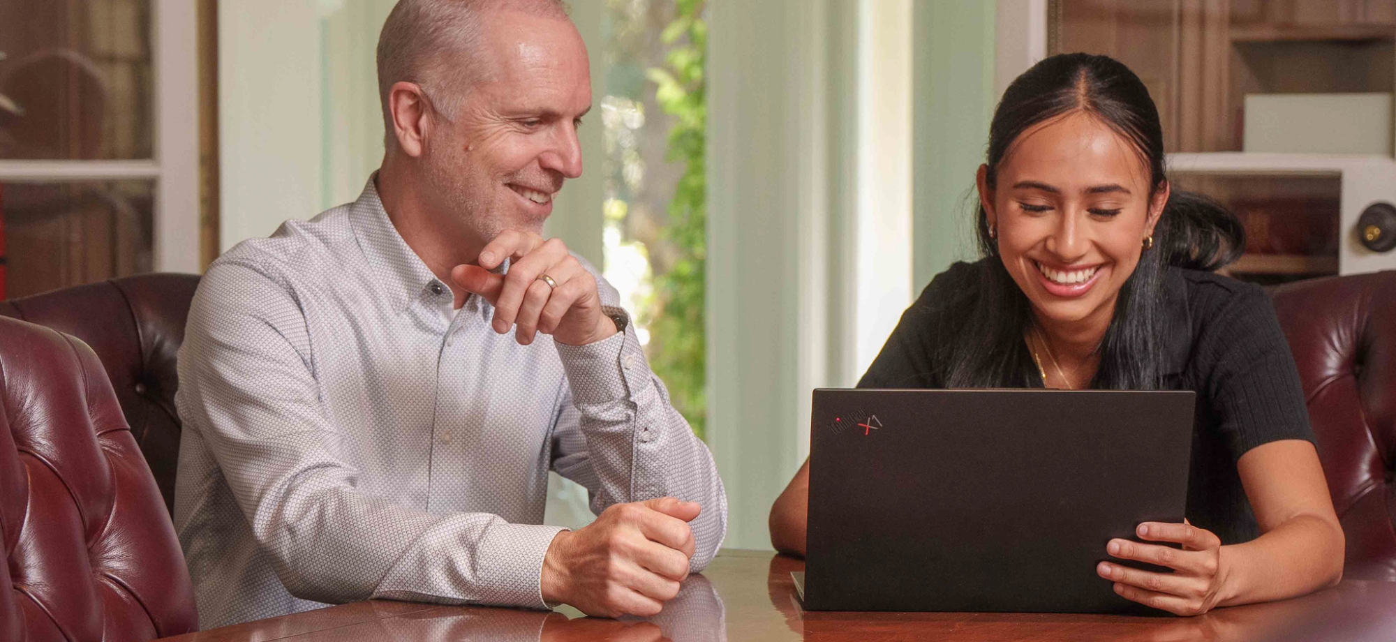 criminology professor working with student in a conference room