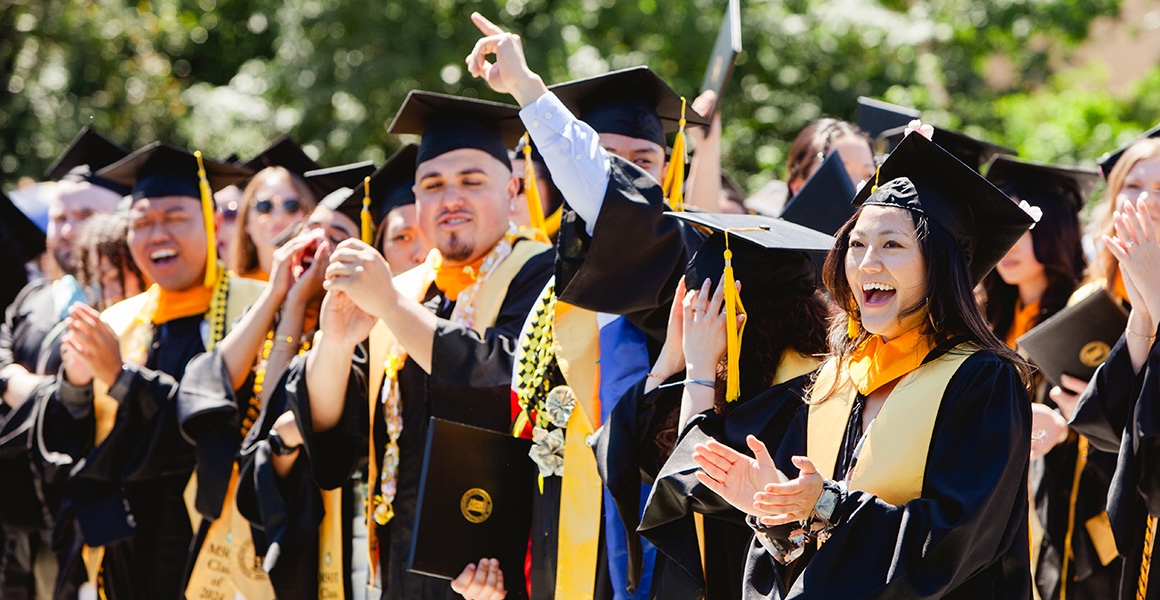 graduates cheering and celebrating