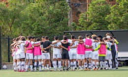 men's soccer team in a huddle