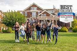 students jumping up in front of meadowlands with the U.S. News badge on the top right corner for Best Regional College West