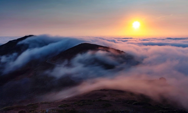 photograph of sunset with mountains in foreground