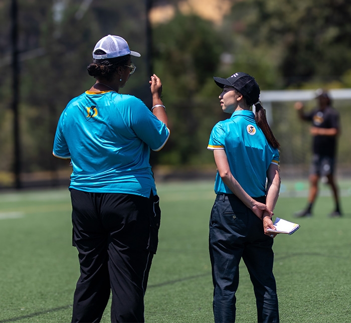 2 graduate students coaching on Dominican soccer field